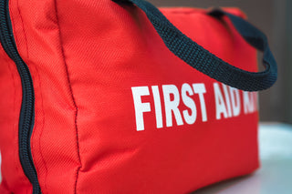 First aid kit with tweezers, gauze pads, antiseptic, and bandages